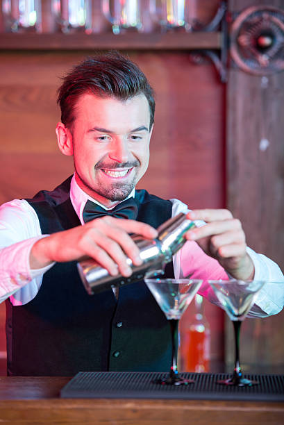 Bartender is making cocktail at bar counter